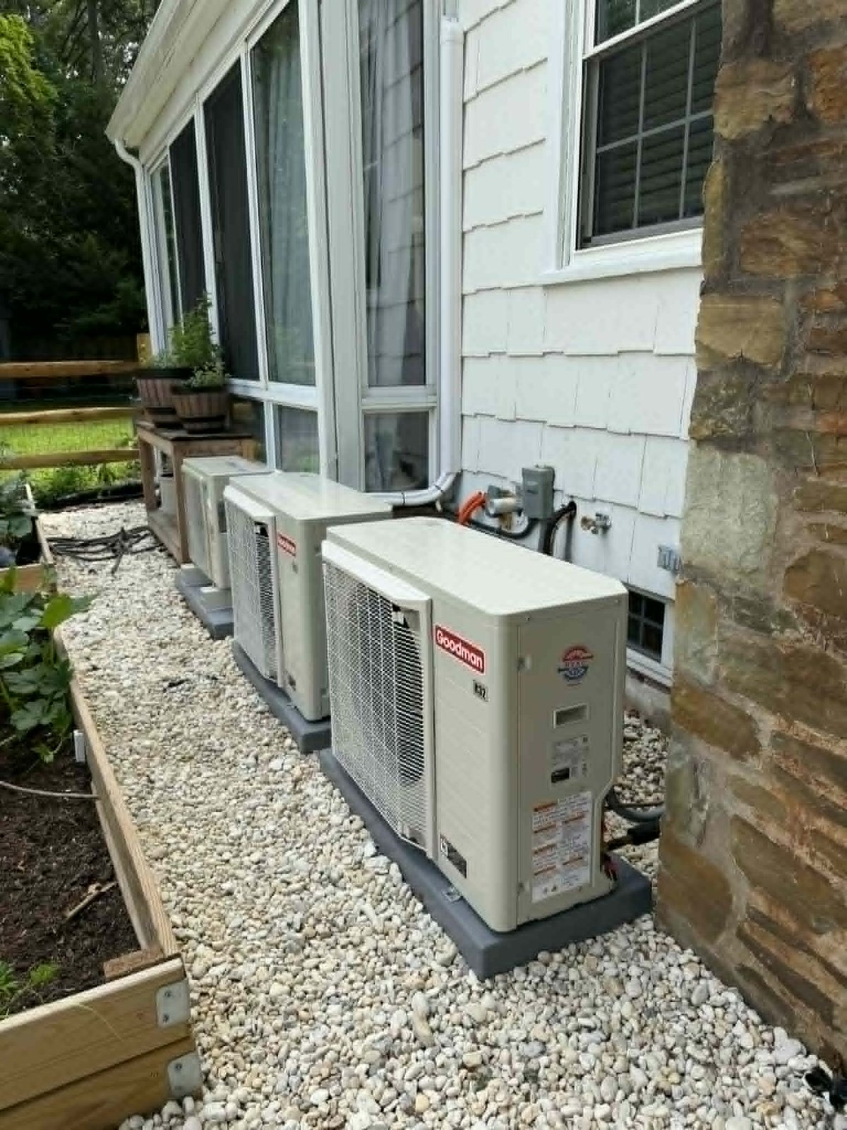 Goodman R-32 side-discharge inverter heat pump units installed in a narrow side yard in Bucks County, PA