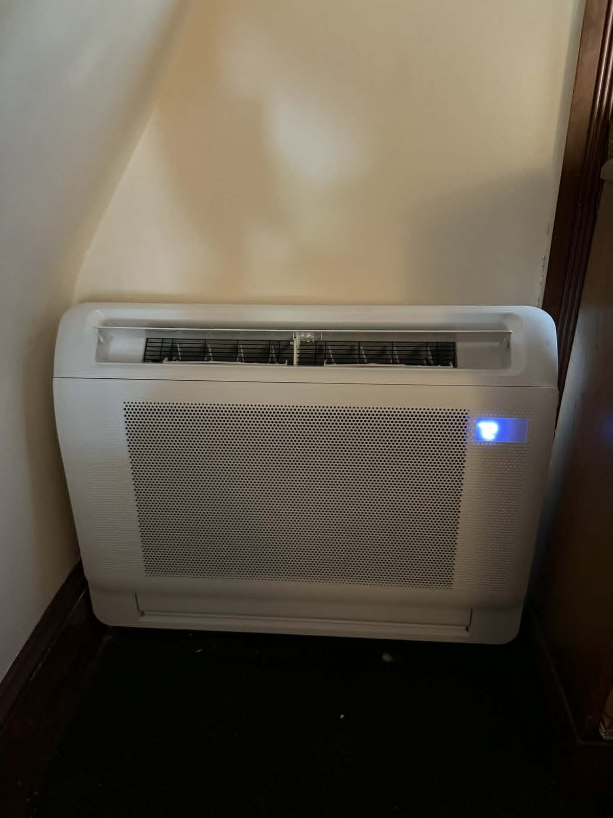 Close-up of a floor-mounted ductless mini-split indoor air handler unit