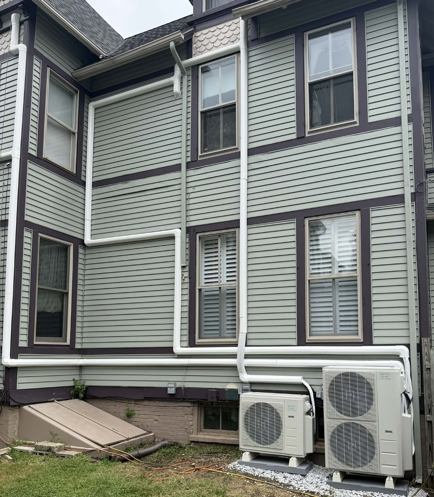Ductless mini-split heat pump condensers mounted on the exterior of a home in Bucks County, PA