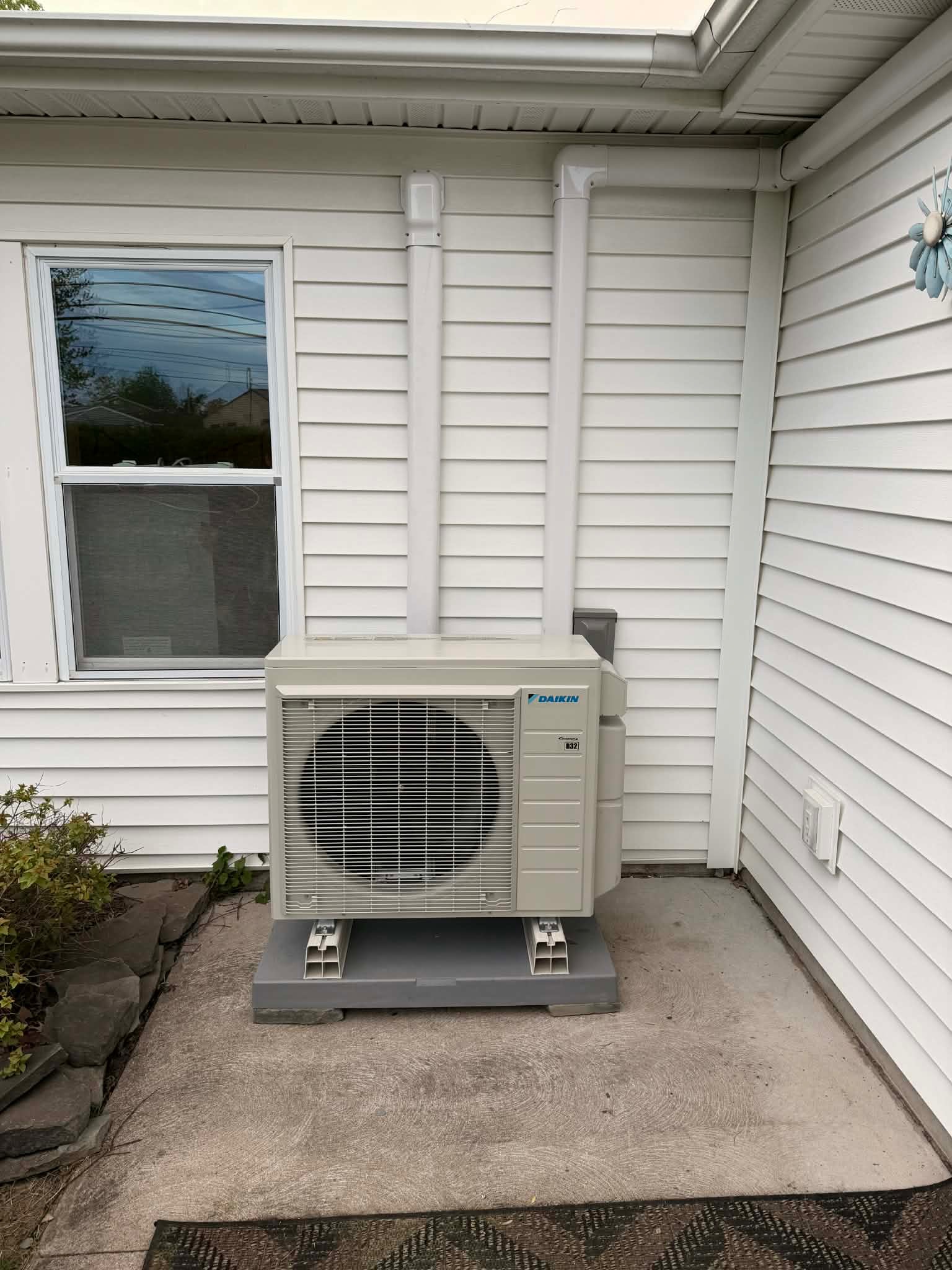 Daikin R32 mini-split heat pump outdoor unit on a residential install